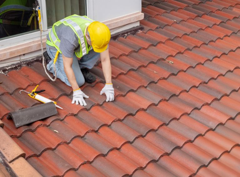 A professional from Hira Roofing conducting a thorough roof inspection.